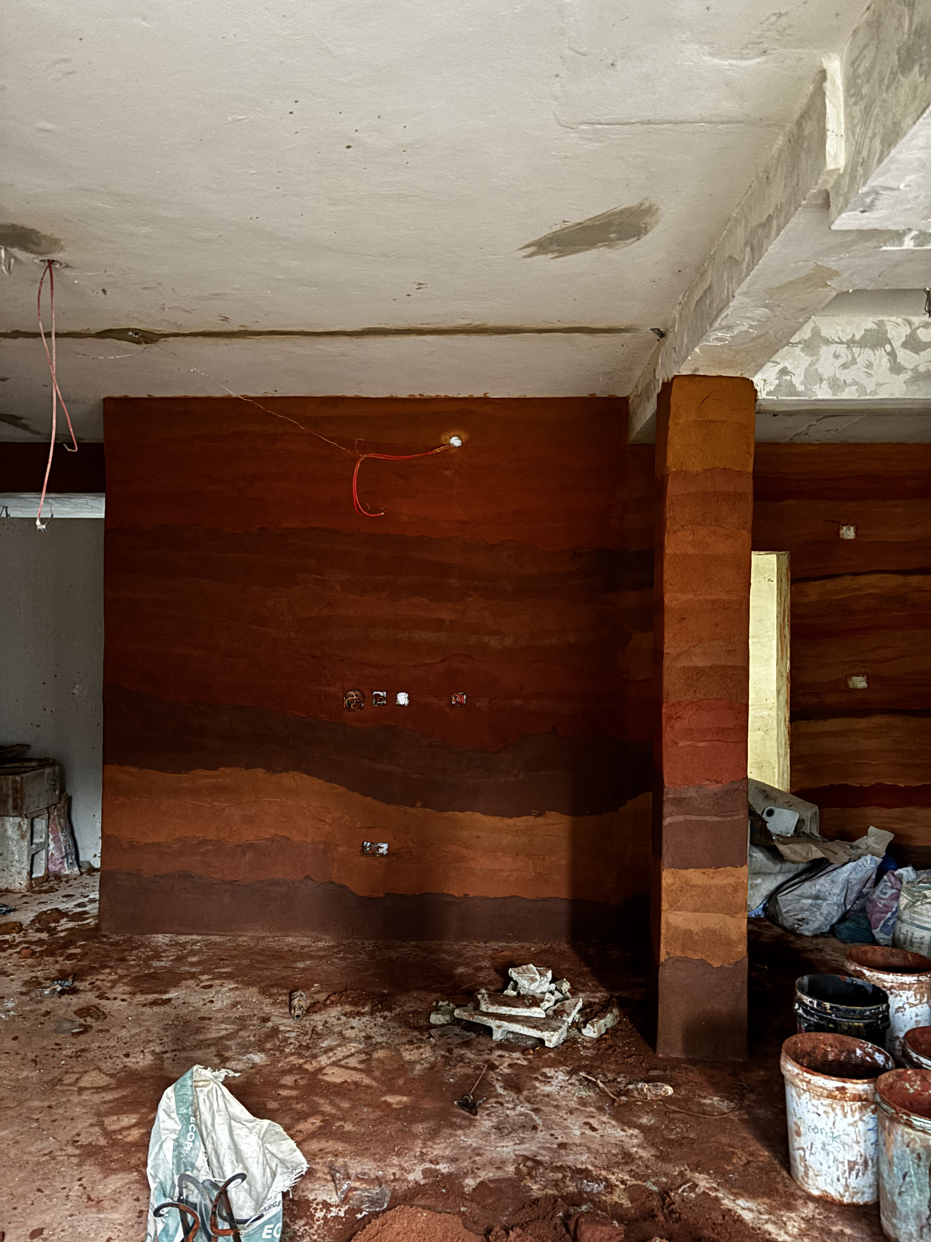 Rammed earth plaster finish sample on a wall